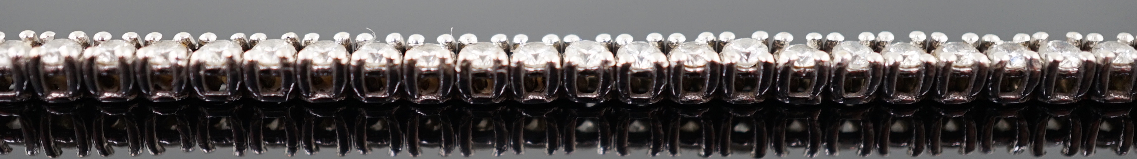 A modern 18ct white gold and diamond set line bracelet